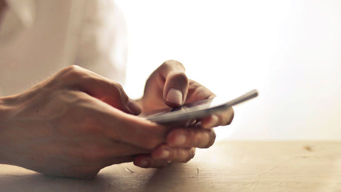 close up photo of hand holding a naked phone