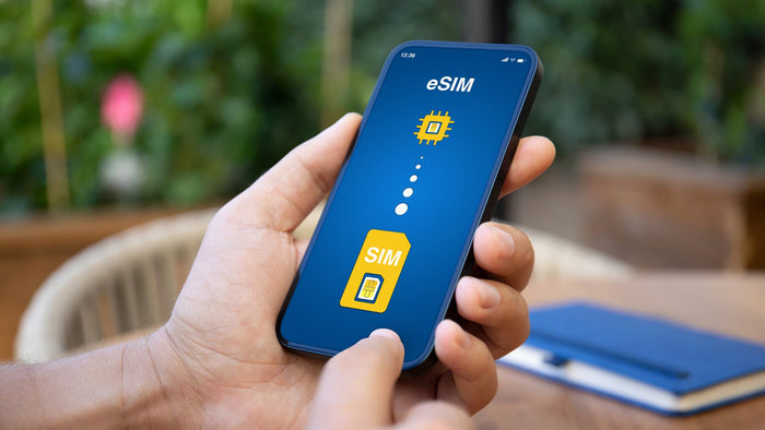 close up photo of hands holding phone with eSIM activation concept on the screen