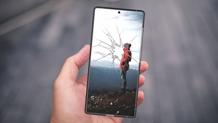 closeup photo of phone with a broken screen