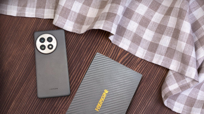 ultra-thin aramid fiber case for OnePlus 13 on top of table with wooden box